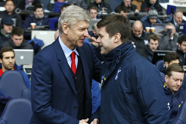 Arsenal's head coach Arsene Wenger, left, shakes hands with Tottenham’s manager Mauricio Pochettino before the English Premier League soccer match between Tottenham Hotspur and Arsenal at the White Hart Lane stadium in London, Saturday, Feb. 7, 2015. (AP Photo/Alastair Grant)