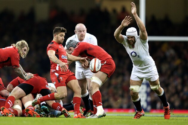 CARDIFF, WALES - FEBRUARY 06:  Rhys Webb of Wales clears the ball under pressure from Dave Attwood of England during the RBS Six Nations match between Wales and England at the Millennium Stadium on February 6, 2015 in Cardiff, Wales.  (Photo by Clive Mason/Getty Images)