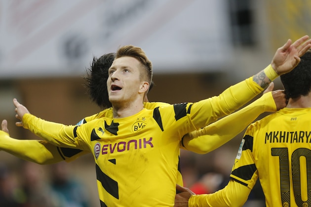 Dortmund's Marco Reus celebrates his side's second goal during the German first division Bundesliga soccer match between SC Paderborn 07 and Borussia Dortmund in Paderborn, Germany, Saturday, Nov.22, 2014. (AP Photo/Michael Probst)