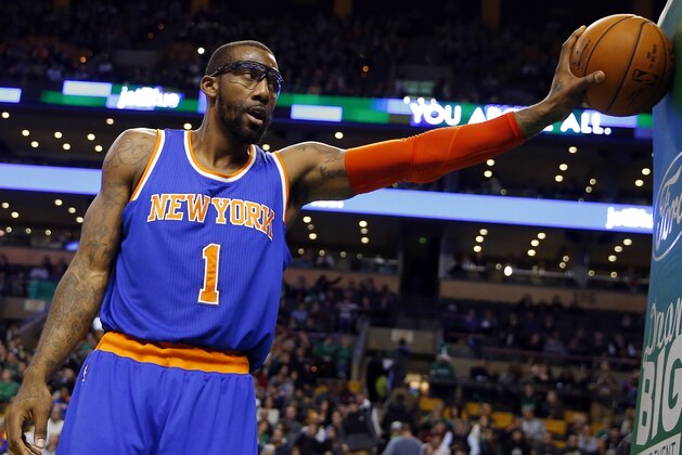 New York Knicks' Amar'e Stoudemire pauses with the ball during the second half of the New York Knicks 101-95 win in an NBA basketball game in Boston Friday, Dec. 12, 2014. (AP Photo/Winslow Townson)