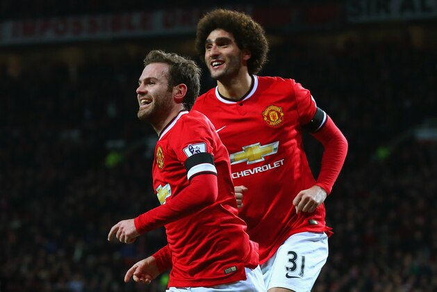 MANCHESTER, ENGLAND - FEBRUARY 03:  Juan Mata of Manchester United celebrates scoring the opening goal with Marouane Fellaini of Manchester United during the FA Cup Fourth round replay match between Manchester United and Cambridge United at Old Trafford on February 3, 2015 in Manchester, England.  (Photo by Alex Livesey/Getty Images)