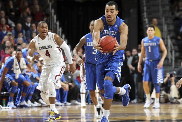 Kentucky forward Trey Lyles rushes down court after stealing a pass as South Carolina defender Tyrone Johnson (4) tries to catch up to the action in the first half of an NCAA college basketball game, Saturday, Jan. 24, 2015, at the Colonial Life Arena in Columbia, S.C. (AP Photo/Willis Glassgow)