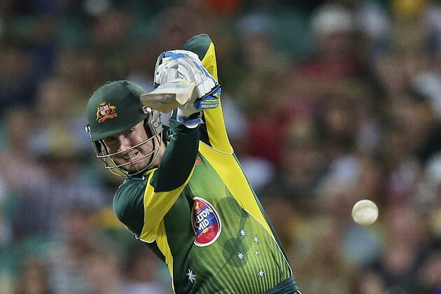 FILE - In this Jan. 19, 2014 file photo, Australia's captain Michael Clarke drives the ball during their one-day international cricket match against England at the Sydney Cricket Ground in Sydney, Australia. Despite the No. 1 ranking and resounding series wins over India and England this summer, though, the World Cup co-hosts are dealing with uncertainty over the composition of the squad due to injuries and the status of Michael Clarke’s captaincy. (AP Photo/Rob Griffith, File)