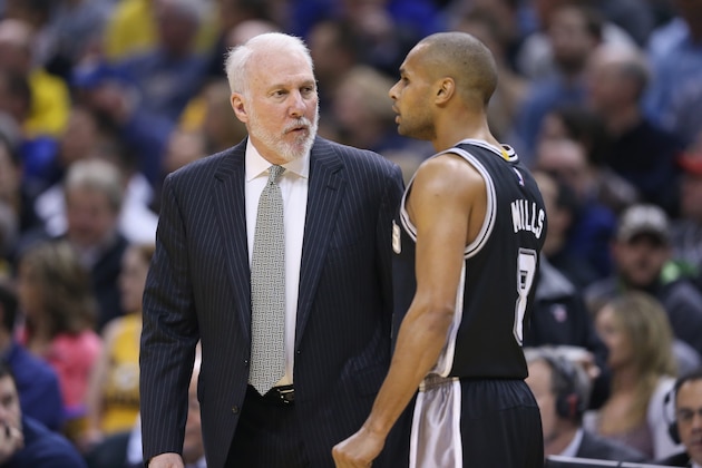 INDIANAPOLIS, IN - FEBRUARY 09:  Gregg Popovich the head coach of the San Antonio Spurs gives instructions to Patty Mills #8 during the game in which he earned his 1,000th career for his NBA career against the Indiana Pacers at Bankers Life Fieldhouse on February 9, 2015 in Indianapolis, Indiana.  NOTE TO USER: User expressly acknowledges and agrees that, by downloading and or using this Photograph, user is consenting to the terms and conditions of the Getty Images License Agreement.  (Photo by Andy Lyons/Getty Images)