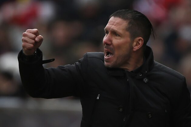 Atletico's coach Diego Simeone celebrates a goal during a Spanish La Liga soccer match between Atletico Madrid and Real Madrid at the Vicente Calderon stadium in Madrid, Spain, Saturday, Feb. 7, 2015. (AP Photo/Andres Kudacki)