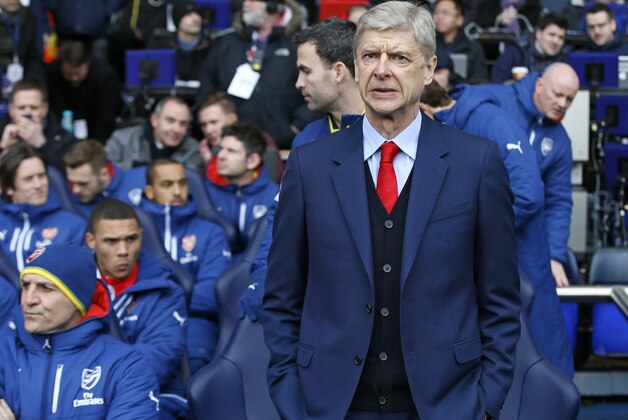 Arsenal's head coach Arsene Wenger stands on the touchline before the English Premier League soccer match between Tottenham Hotspur and Arsenal at the White Hart Lane stadium in London, Saturday, Feb. 7, 2015. (AP Photo/Alastair Grant)