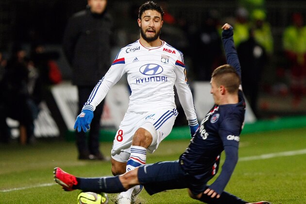 Lyon's French midfielder Nabil Fekir, left, challenges Paris Saint Germain's Italian midfielder Marco Verrati for the ball during the League One soccer match between Lyon and Paris Saint-Germain, at the Gerland Stadium, in Lyon, central France, Sunday Feb. 8, 2015. (AP Photo/Claude Paris)