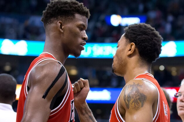 Nov 24, 2014; Salt Lake City, UT, USA; Chicago Bulls guard Derrick Rose (right) and guard Jimmy Butler (21) react to defeating the Utah Jazz 97-95 at EnergySolutions Arena. Mandatory Credit: Russ Isabella-USA TODAY Sports