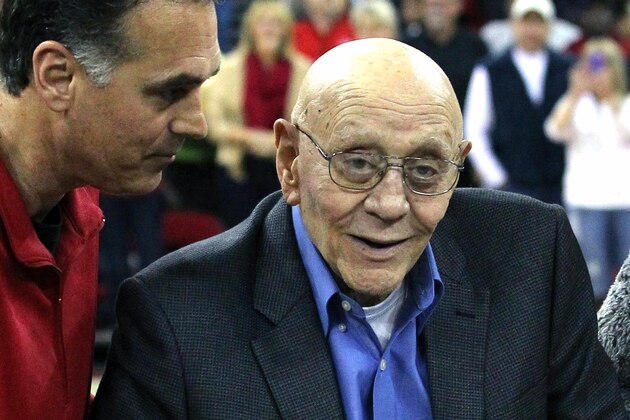 FILE - In this March 1, 2014, file photo, Jerry Tarkanian is escorted by his son, Danny, during halftime ceremonies honoring the former basketball coach at Fresno State University in Fresno, Calif. Family members say Hall of Fame basketball coach Tarkanian is hospitalized in Las Vegas with breathing trouble and some type of infection. Son Danny Tarkanian on Tuesday characterized his father’s condition as “minute by minute.” He says his 84-year-old father was taken by ambulance Monday, Feb. 10, 2015, to Valley Hospital Medical Center after his blood oxygen fell to dangerous levels. (AP Photo/Gary Kazanjian, File)