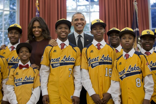 President Barack Obama and first lady Michelle Obama pose with members of the Jackie Robinson West All Stars little league team in the Oval Office of the White House in Washington, Thursday, Nov. 6, 2014. The little league team, from the South Side of Chicago, won the national championship but lost the world title game to South Korean in August, are visiting Washington and the White House at the invitation of the President. (AP Photo/Pablo Martinez Monsivais)