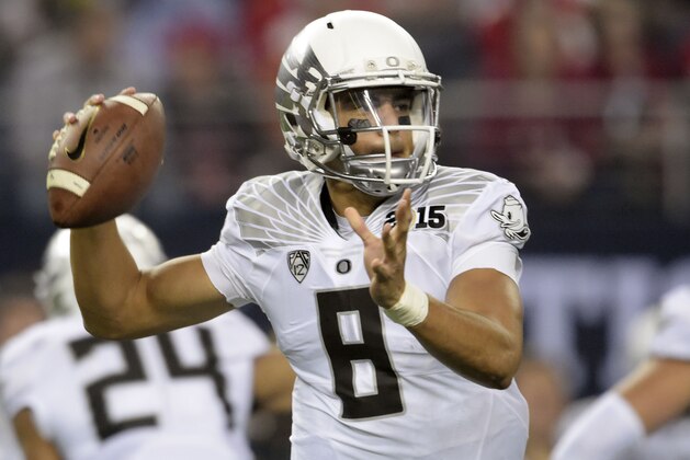 Jan 12, 2015; Arlington, TX, USA; Oregon Ducks quarterback Marcus Mariota (8) looks to pass during the first quarter against the Ohio State Buckeyes in the 2015 CFP National Championship Game at AT&T Stadium. Mandatory Credit: Kirby Lee-USA TODAY Sports