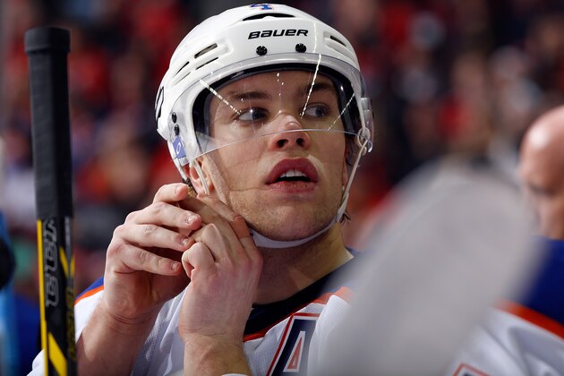 CALGARY, AB - DECEMBER 31: Taylor Hall #4 of the Edmonton Oilers adjusts his chin strap in between shifts against the Calgary Flames at Scotiabank Saddledome on December 31, 2014 in Calgary, Alberta, Canada. (Photo by Gerry Thomas/NHLI via Getty Images)