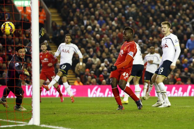 Liverpool's Mario Balotelli, center, score against Tottenham during the English Premier League soccer match between Liverpool and Tottenham Hotspur at Anfield Stadium, Liverpool, England, Tuesday Feb. 10, 2015. (AP Photo/Jon Super)