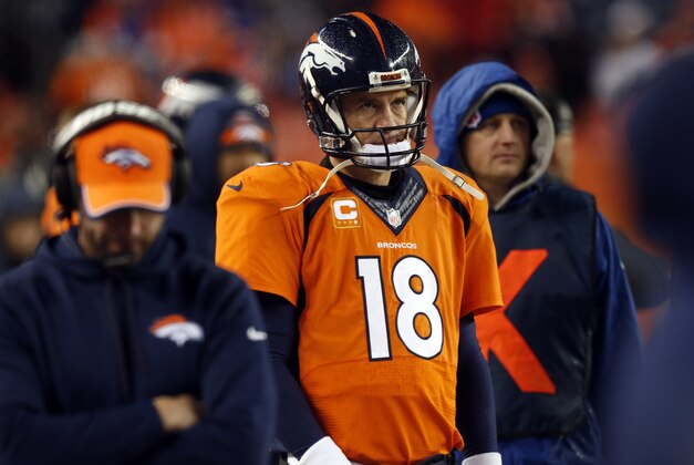 Denver Broncos quarterback Peyton Manning (18) watches the final seconds of an NFL divisional playoff football game against the Indianapolis Colts, Sunday, Jan. 11, 2015, in Denver. The Colts won 24-13 to advance to the AFC Championship game against the New England Patriots. (AP Photo/David Zalubowski)