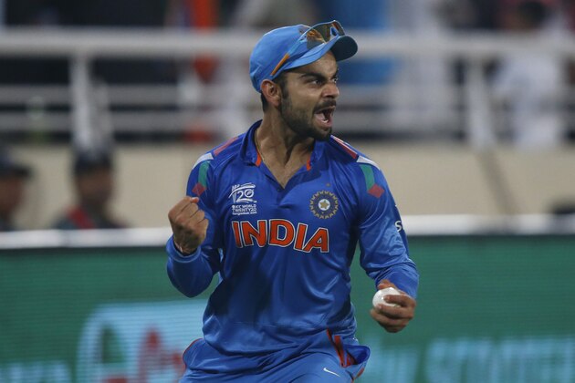 India's Virat Kohli celebrates taking the catch to dismiss Sri Lanka's batsman Tillakaratne Dilshan during their ICC Twenty20 Cricket World Cup final match in Dhaka, Bangladesh, Sunday, April 6, 2014. (AP Photo/Aijaz Rahi)