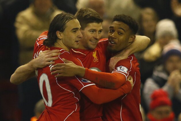 Liverpool's Steven Gerrard, center, celebrates scoring with teammates Lazar Markovic, left, and Jordon Ibe during the English Premier League soccer match between Liverpool and Tottenham Hotspur at Anfield Stadium, Liverpool, England, Tuesday Feb. 10, 2015. (AP Photo/Jon Super)