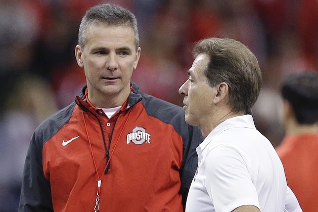 Ohio State head coach Urban Meyer, left, speaks with Alabama head coach Nick Saban before the Sugar Bowl NCAA college football playoff semifinal game, Thursday, Jan. 1, 2015, in New Orleans. (AP Photo/Brynn Anderson)