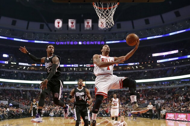 Chicago Bulls guard Derrick Rose (1) drives past Sacramento Kings guard Ben McLemore (23) as Jason Thompson (34) watches during the first half of an NBA basketball game Tuesday, Feb. 10, 2015, in Chicago. (AP Photo/Charles Rex Arbogast)