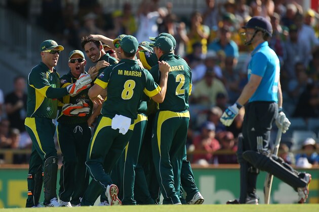 PERTH, AUSTRALIA - FEBRUARY 01:  Mitchell Johnson of Australia is congratulated by team mates after the dismissal Eoin Morgan of England during the final match of the Carlton Mid One Day International series between Australia and England at WACA on February 1, 2015 in Perth, Australia.  (Photo by Paul Kane/Getty Images)