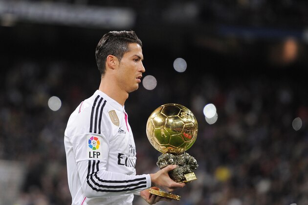MADRID, SPAIN - JANUARY 15:  Cristiano Ronaldo of Real Madrid salutes with his FIFA Ballon d'Or before the Copa del Rey Round of 16, Second leg match between Real Madrid and Atletico de Madrid at Estadio Santiago Bernabeu on January 15, 2015 in Madrid, Spain.  (Photo by Denis Doyle/Getty Images)