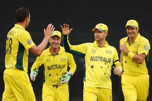 MELBOURNE, AUSTRALIA - FEBRUARY 11:  Josh Hazlewood of Australia (L) celebrates a wicket with Michael Clarke (C) during the Cricket World Cup warm up match between Australia and the United Arab Emirates at Melbourne Cricket Ground on February 11, 2015 in Melbourne, Australia.  (Photo by Michael Dodge/Getty Images)