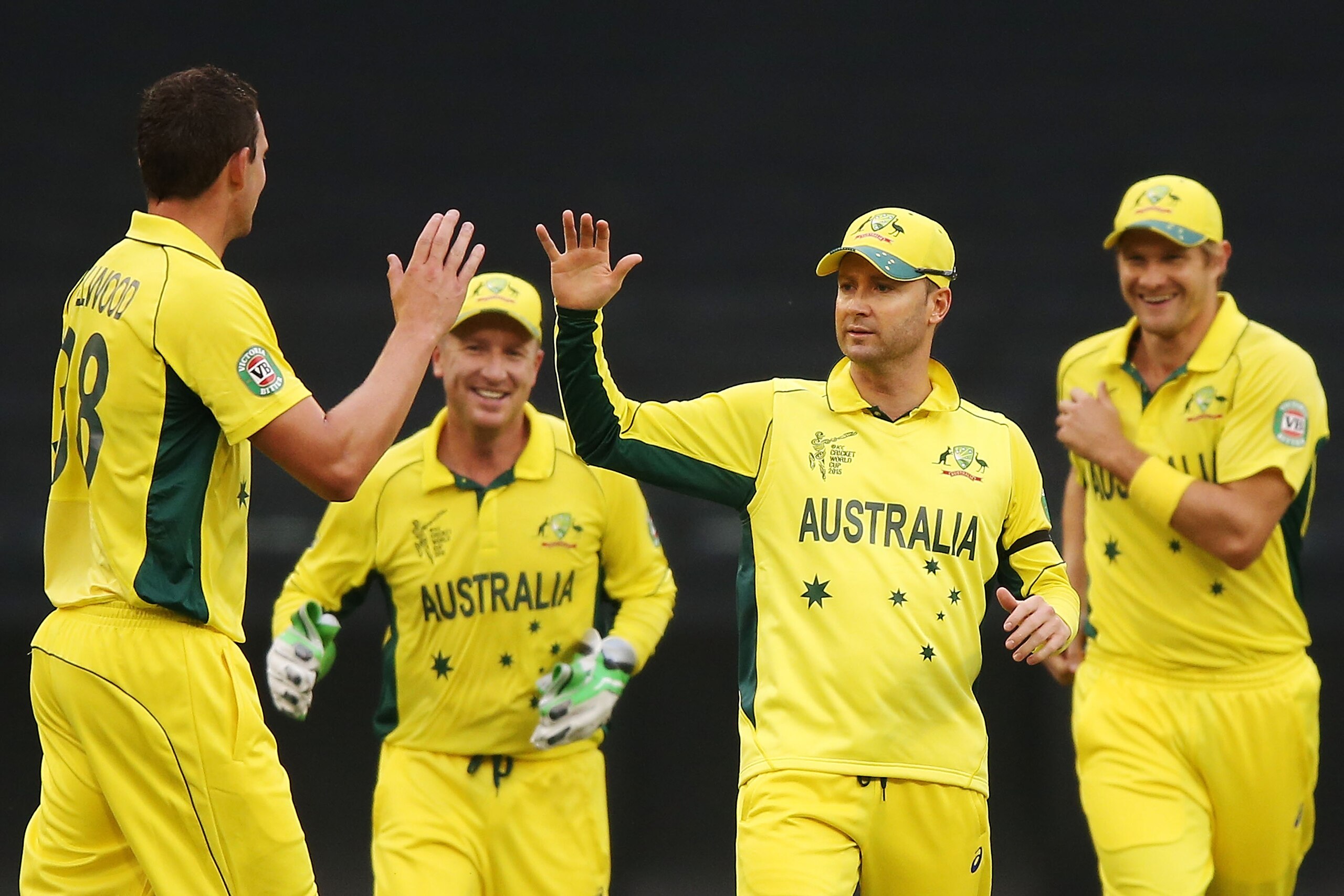 MELBOURNE, AUSTRALIA - FEBRUARY 11:  Josh Hazlewood of Australia (L) celebrates a wicket with Michael Clarke (C) during the Cricket World Cup warm up match between Australia and the United Arab Emirates at Melbourne Cricket Ground on February 11, 2015 in Melbourne, Australia.  (Photo by Michael Dodge/Getty Images)