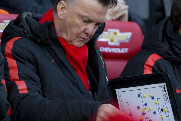 Manchester United's manager Louis van Gaal  takes his seat before his team's English Premier League soccer match between Manchester United and Leicester at Old Trafford Stadium, Manchester, England, Saturday Jan. 31, 2015. (AP Photo/Jon Super)