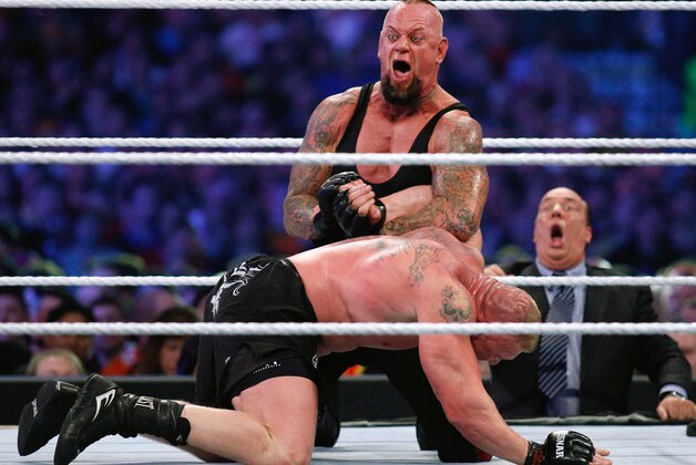 IMAGE DISTRIBUTED FOR WWE - The Undertaker, top, and Brock Lesnar wrestle during Wrestlemania XXX at the Mercedes-Benz Super Dome in New Orleans on Sunday, April 6, 2014. (Jonathan Bachman/AP Images for WWE)