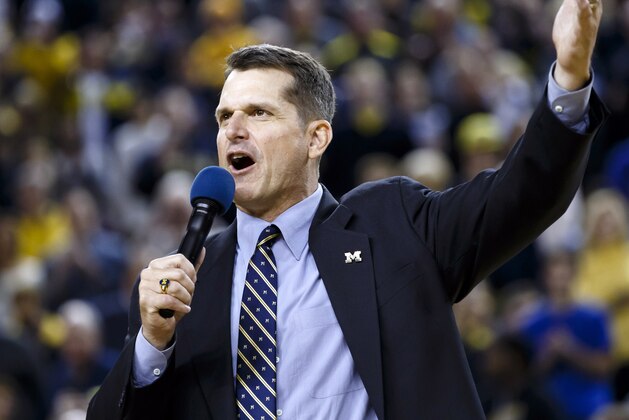 Dec 30, 2014; Ann Arbor, MI, USA; Michigan Wolverines head football coach Jim Harbaugh address the crowd during halftime of the game against the Illinois Fighting Illini at Crisler Center. Mandatory Credit: Rick Osentoski-USA TODAY Sports