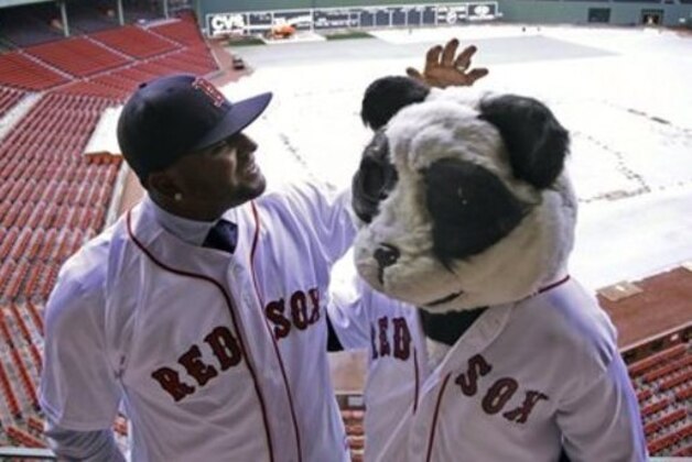 CORRECTS TO TARP COVERED, NOT SNOW COVERED - Newly acquired Boston Red Sox free agent third baseman Pablo Sandoval, nicknamed Kung Fu Panda, converses with a person dressed as a panda bear wearing a Red Sox jersey, overlooking a tarp covered Fenway Park field Tuesday, Nov. 25, 2014 in Boston. (AP Photo/Stephan Savoia)