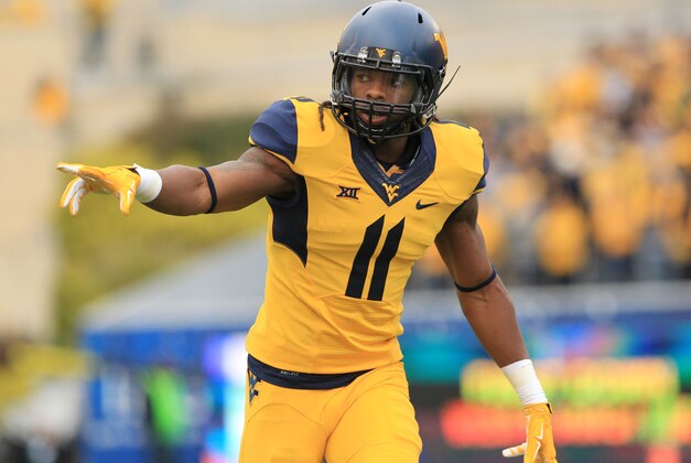 West Virginia's Kevin White (11) checks is lineup during their NCAA college football game against Kansas in Morgantown, W.Va., Saturday, Oct. 4, 2014. West Virginia won 33-14. (AP Photo/Chris Jackson)