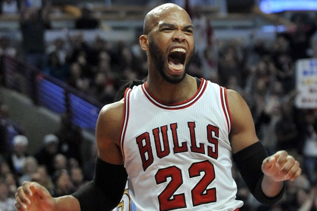 Chicago Bulls' Taj Gibson (22) celebrates after dunking during the second half of an NBA basketball game against the Denver Nuggets in Chicago, Thursday, Jan. 1, 2015. Chicago won 106-101. (AP Photo/Paul Beaty)