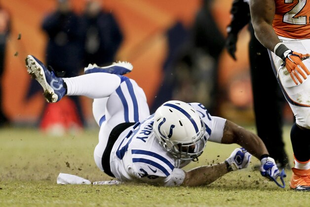 Denver Broncos running back C.J. Anderson, right, breaks free from Indianapolis Colts free safety LaRon Landry on a fourth down run for the first down during the second half of an NFL divisional playoff football game, Sunday, Jan. 11, 2015, in Denver. (AP Photo/Joe Mahoney)