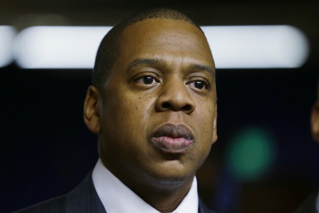 Rap artist Jay Z one of the founders of Roc Nation Sports listens to speakers during an event honoring his client Robinson Cano as the newest member of the Seattle Mariners baseball team, Thursday, Dec. 12, 2013, in Seattle. (AP Photo/Ted S. Warren)