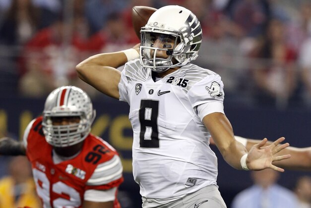 Jan 12, 2015; Arlington, TX, USA; Oregon Ducks quarterback Marcus Mariota (8) throws a touchdown pass to wide receiver Keanon Lowe (not pictured) in the first quarter against the Ohio State Buckeyes in the 2015 CFP National Championship Game at AT&T Stadium. Mandatory Credit: Matthew Emmons-USA TODAY Sports