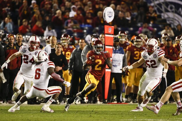 Southern California Adoree' Jackson is surrounded by Nebraska defenders as he breaks loose on a 71 yard touchdown reception during the second half of the Holiday Bowl football game won 45-42 by Southern California Saturday, Dec. 27, 2014, in San Diego. (AP Photo/Lenny Ignelzi)