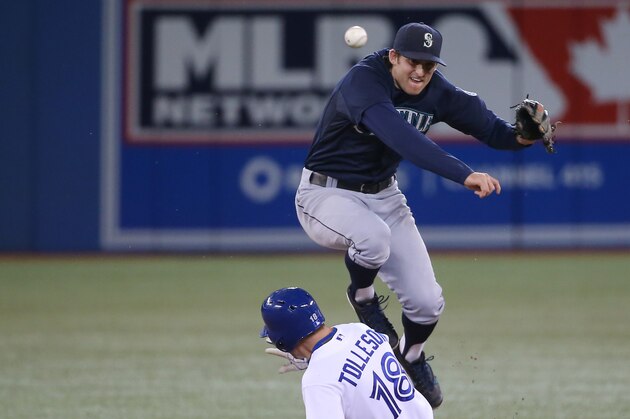 TORONTO, CANADA - SEPTEMBER 22: Brad Miller #5 of the Seattle Mariners gets the force out at second base but cannot turn the double play in the eighth inning during MLB game action as Steve Tolleson #18 of the Toronto Blue Jays slides on September 22, 2014 at Rogers Centre in Toronto, Ontario, Canada. (Photo by Tom Szczerbowski/Getty Images)