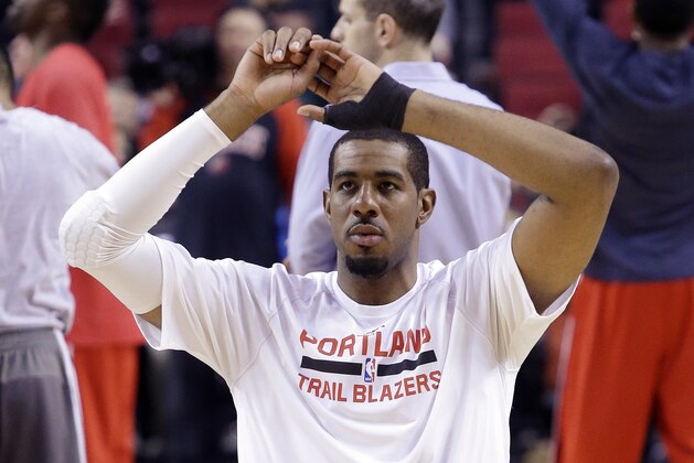 Portland Trail Blazers forward LaMarcus Aldridge sports a brace on his left hand as he stretches before the team's NBA basketball game against the Washington Wizards in Portland, Ore., Saturday, Jan. 24, 2015. Aldridge had said on Thursday that he needed surgery to repair a ligament in his left thumb and was expected to miss from six to eight weeks. But just hours before the game against the Wizards, the Blazers announced on Twitter that the three-time All-Star would play. (AP Photo/Don Ryan)