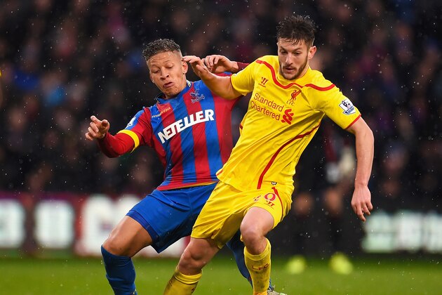 LONDON, ENGLAND - NOVEMBER 23: Dwight Gayle of Crystal Palace tackles Adam Lallana of Liverpool during the Barclays Premier League match between Crystal Palace and Liverpool at Selhurst Park on November 23, 2014 in London, England.  (Photo by Mike Hewitt/Getty Images)