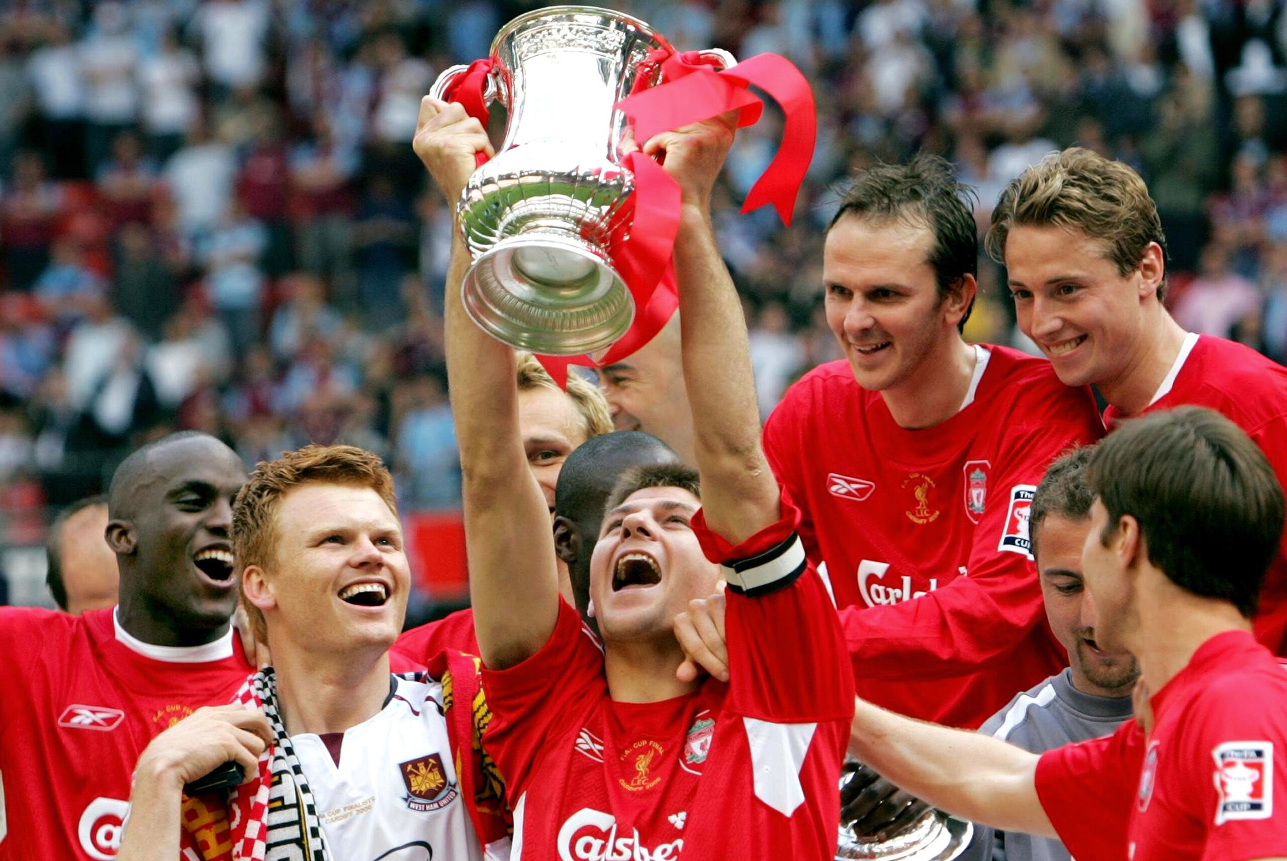 Liverpool's Steven Gerrard celebrates with the trophy after the FA Cup final soccer match against West Ham United at the Millennium Stadium, Cardiff, Saturday May 13, 2006. Liverpool won 3-1 on penalties after the match ended 3-3 after extra time. (AP Photo/David Davies, Pool)