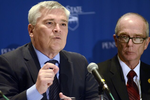 FILE - In this Monday, Feb. 17, 2014, file photo, Eric Barron, left, answers questions from the media after being unanimously voted in to become the Penn State University's 18th president, in State College, Pa. Barron says he hopes the focus will shift away from the Jerry Sandusky child sexual abuse scandal to the many other things going on at Pennsylvania’s largest university. (AP Photo/Ralph Wilson, File)