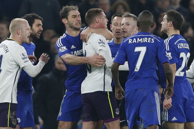 Chelsea's Branislav Ivanovic, third left, holds back Everton’s James McCarthy during a incident which saw the sending off of Everton’s Gareth Barry during their English Premier League soccer match between Chelsea and Everton at Stamford Bridge stadium in London, Wednesday, Feb. 11, 2015. (AP Photo/Alastair Grant)