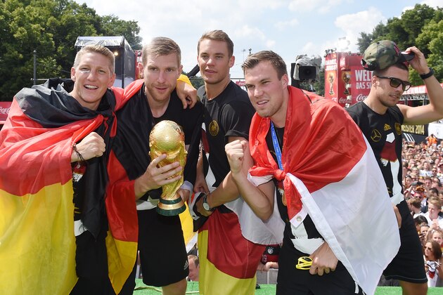 BERLIN, GERMANY - JULY 15: Bastian Schweinsteiger, Per Mertersacker, Manuel Neuer, Kevin Grosskreutz and Lukas Podolski celebrate during the German team victory ceremony on July 15, 2014 in Berlin, Germany. Germany won the 2014 FIFA World Cup Brazil match against Argentina in Rio de Janeiro on July 13.  (Photo by Markus Gilliar - Pool /Getty Images)
