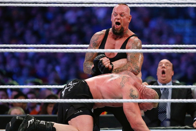 IMAGE DISTRIBUTED FOR WWE - The Undertaker, top, and Brock Lesnar wrestle during Wrestlemania XXX at the Mercedes-Benz Super Dome in New Orleans on Sunday, April 6, 2014. (Jonathan Bachman/AP Images for WWE)
