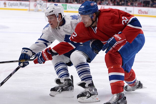 MONTREAL, QC - MARCH 1: Travis Moen #32 of the Montreal Canadiens Jake Gardiner #51 of the Toronto Maple Leafs fight for the puck during the NHL game on March 1, 2014 at the Bell Centre in Montreal, Quebec, Canada. (Photo by Francois Lacasse/NHLI via Getty Images)