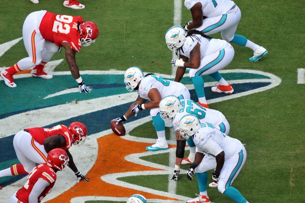 Sep 21, 2014; Miami Gardens, FL, USA; Miami Dolphins offensive line at the line of scrimmage including guard Daryn Colledge (67) and tackle Branden Albert (71) and  offensive tackle Ja'Wuan James (70) in the first quarter of  the game at Sun Life Stadium. Mandatory Credit: Brad Barr-USA TODAY Sports