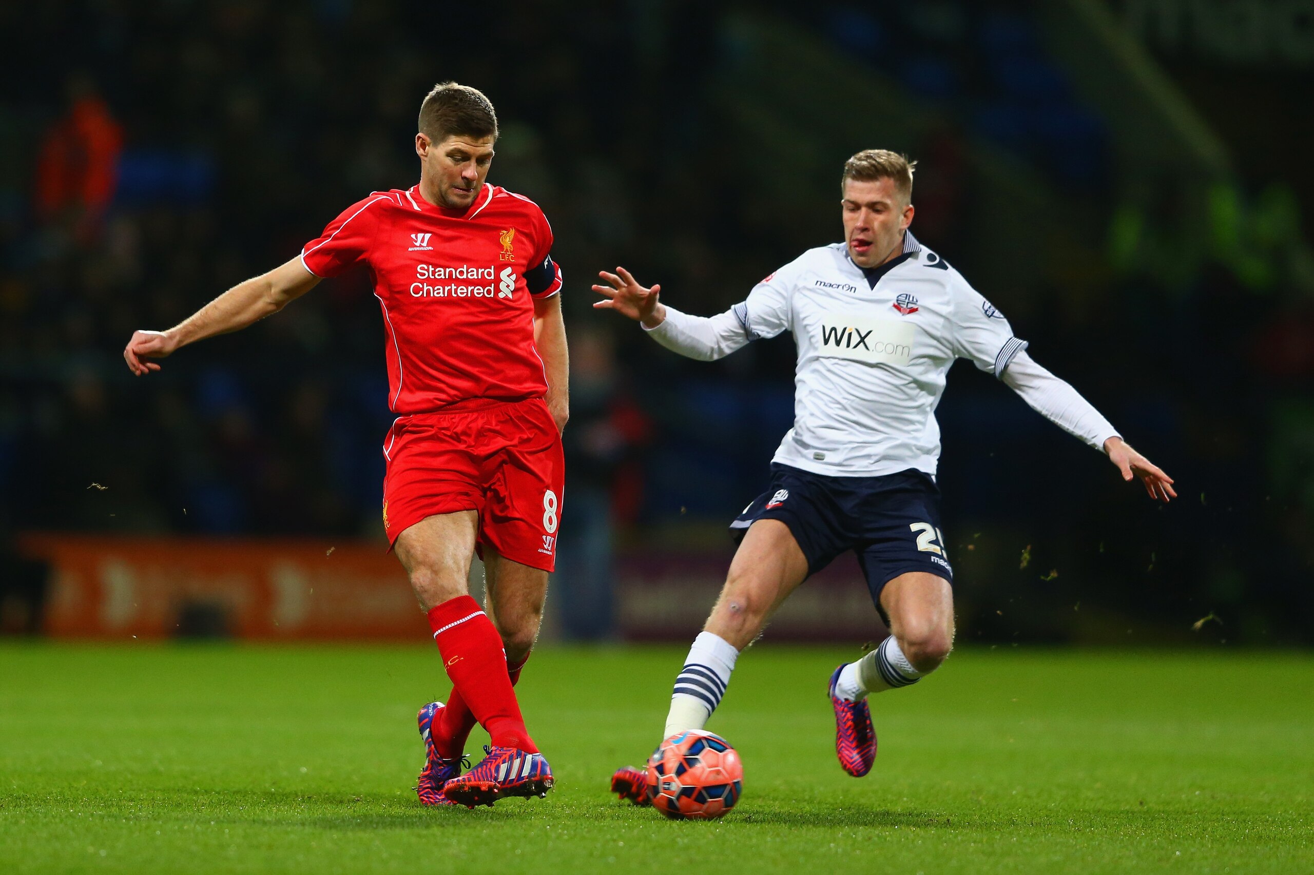 BOLTON, ENGLAND - FEBRUARY 04: Steven Gerrard of Liverpool and Josh Vela of Bolton Wanderers battle for the ball during the FA Cup Fourth round replay between Bolton Wanderers and Liverpool at Macron Stadium on February 4, 2015 in Bolton, England. (Photo by Michael Steele/Getty Images) BOLTON, ENGLAND - FEBRUARY 04: Steven Gerrard of Liverpool and Josh Vela of Bolton Wanderers battle for the ball during the FA Cup Fourth round replay between Bolton Wanderers and Liverpool at Macron Stadium on February 4, 2015 in Bolton, England. (Photo by Michael Steele/Getty Images)