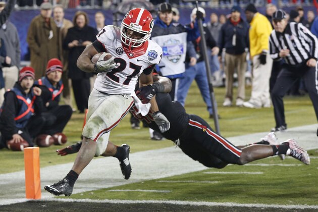 Georgia's Nick Chubb (27) runs into the end for a touchdown against Louisville late in the second half of the Belk Bowl NCAA college football game in Charlotte, N.C., Tuesday, Dec. 30, 2014. Georgia won 37-14. Chubb was the game's MVP. (AP Photo/Nell Redmond)