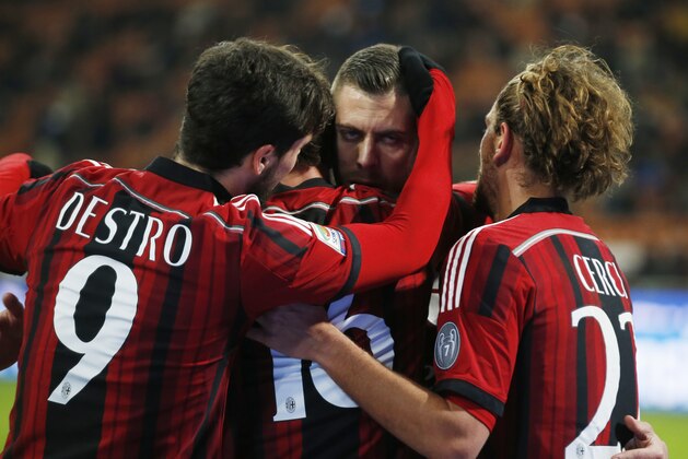 AC Milan's Jeremy Menez, center, celebrates with his teammates Mattia Destro, left, and Alessio Cerci after scoring during a Serie A soccer match between AC Milan and Parma, at the San Siro stadium in Milan, Italy, Sunday, Feb.1, 2015. (AP Photo/Luca Bruno)