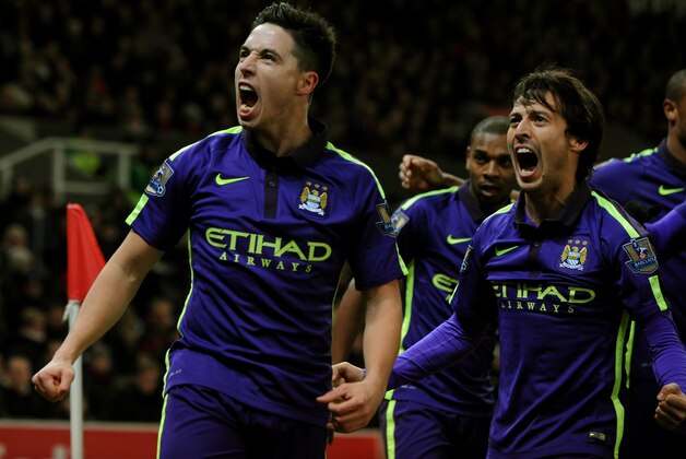 Manchester City's Samir Nasri, left, and David Silva celebrate towards fans after James Milner scored against Stoke during the English Premier League soccer match between Stoke City and Manchester City at the Britannia Stadium, in Stoke on Trent, England, Wednesday, Feb. 11, 2015. (AP Photo/Rui Vieira)
